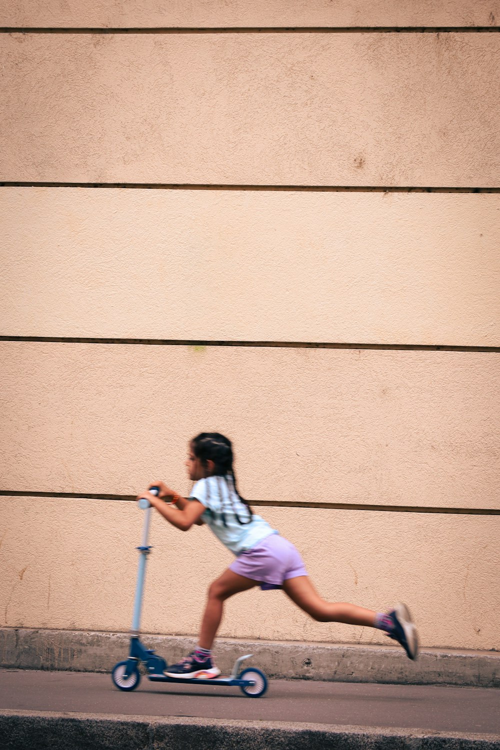 a girl riding a scooter