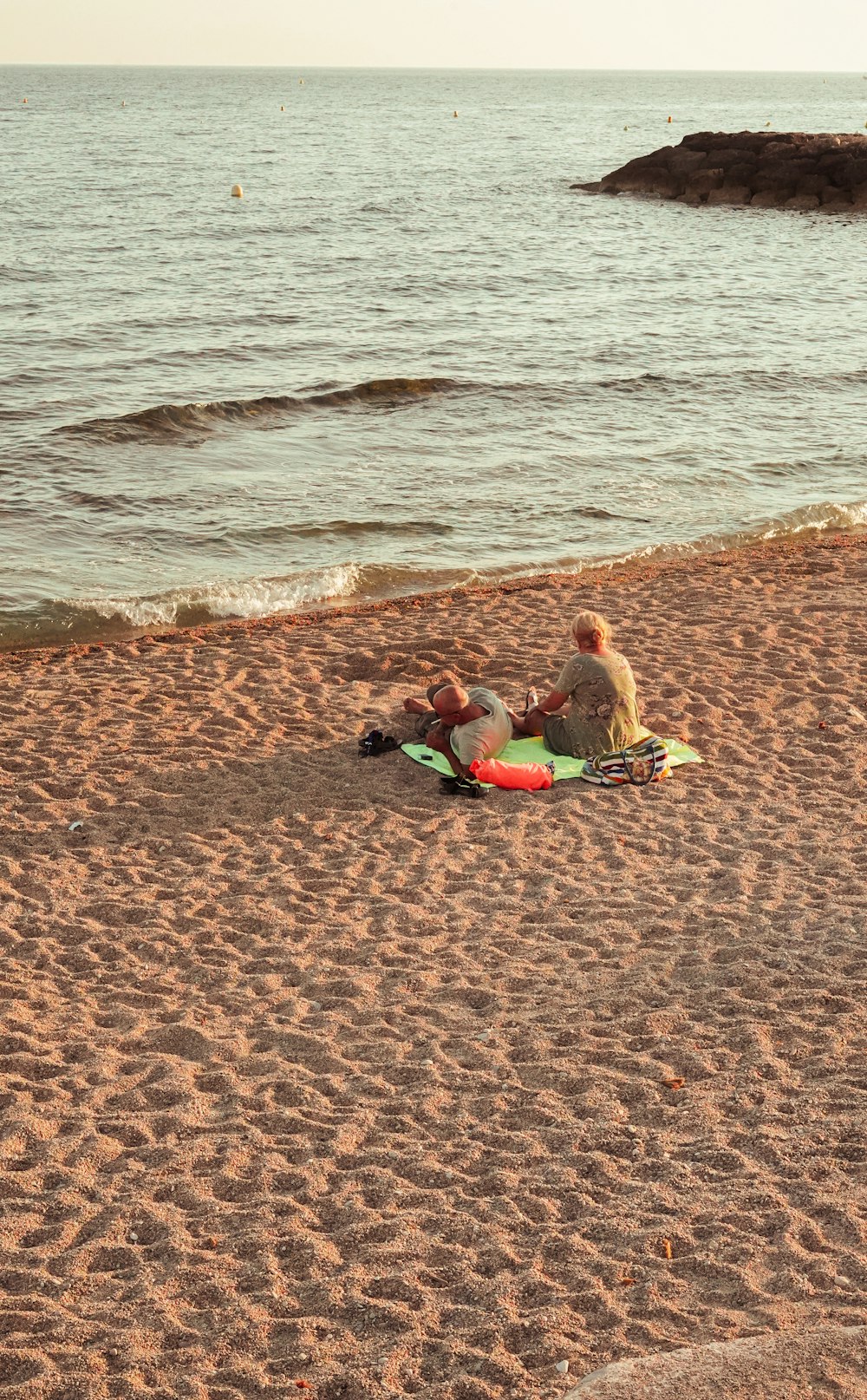 a group of people sitting on a beach