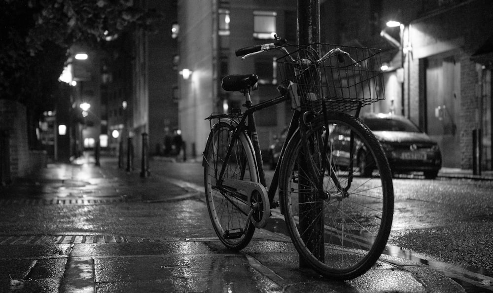 a bicycle parked on a wet street