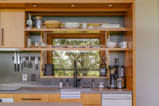 a kitchen with a sink and a mirror