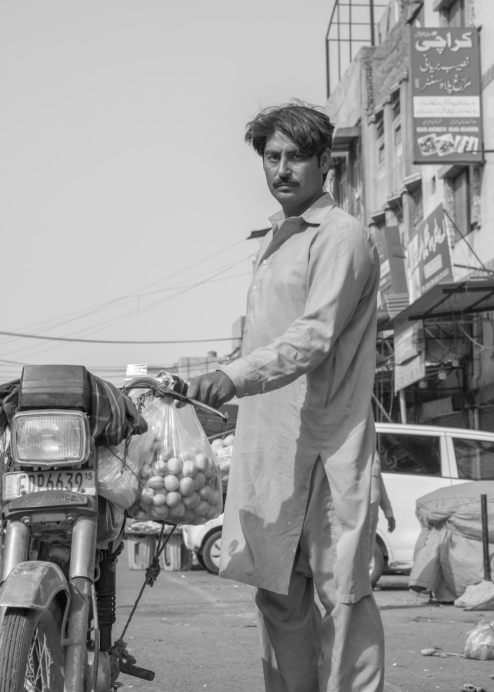 a man carrying a bag of fruit