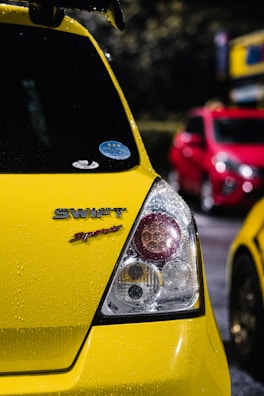 Side view of a polished Maruti Suzuki Swift reflecting showroom lights after detailing.