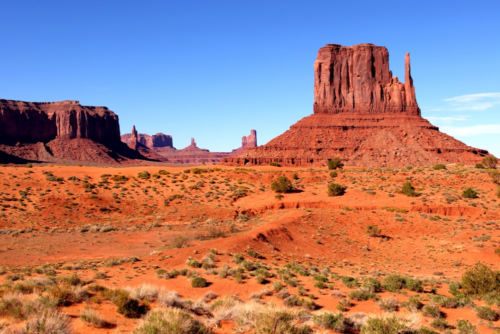 a desert landscape with a few tall red rock formations