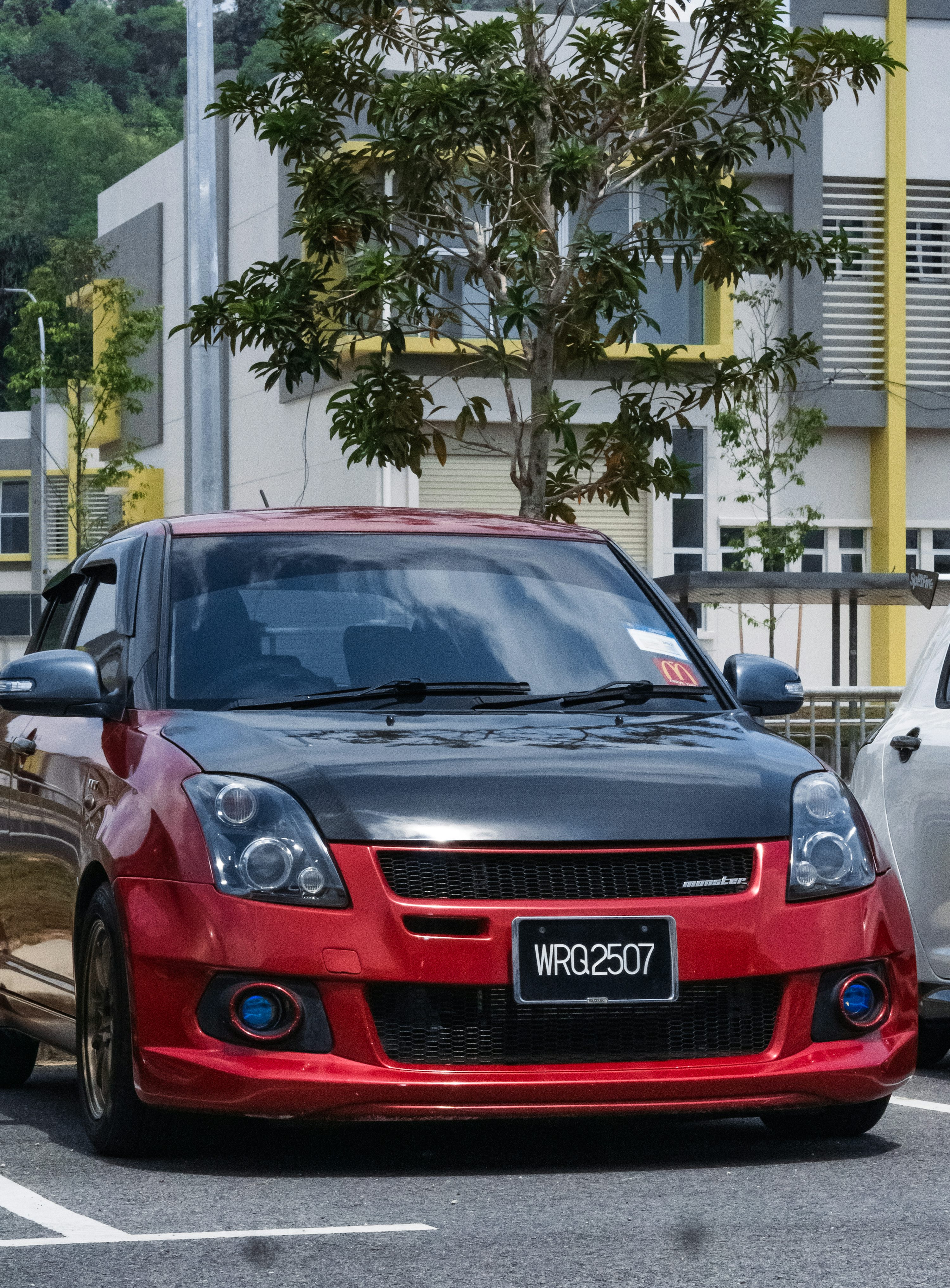 a red car parked on the side of a road