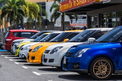 A row of rental cars lined up in a parking lot