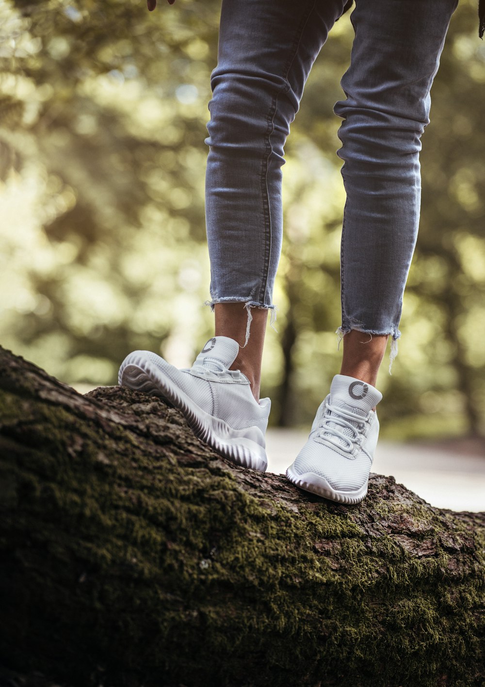 a person's legs and feet on a rock