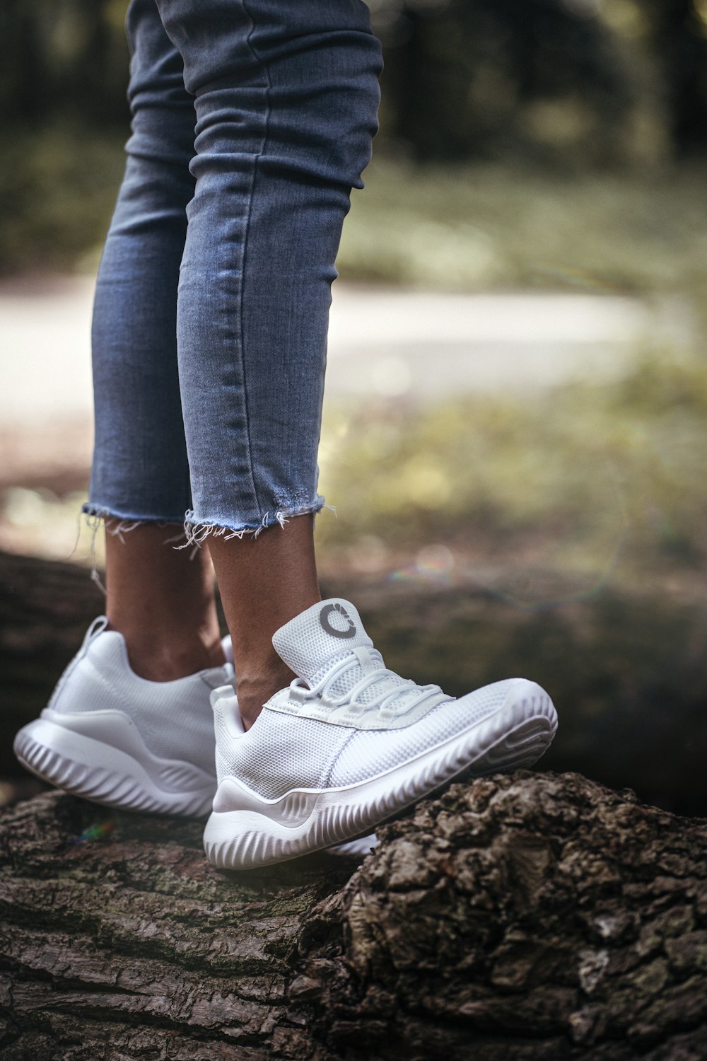 a pair of legs with white sneakers
