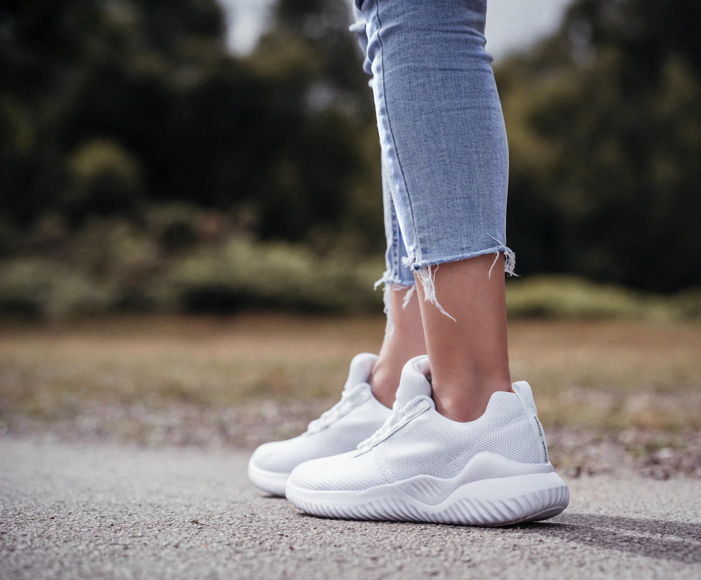 Woman walking briskly on a park path
