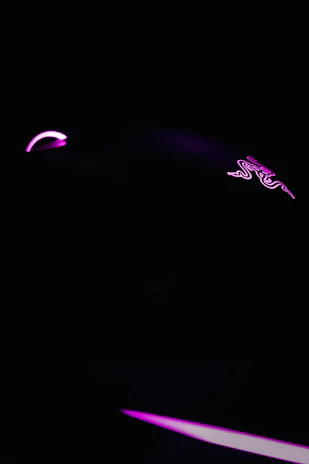 A sleek dark-themed digital storefront showcasing vibrant game key icons glowing softly against a black background.