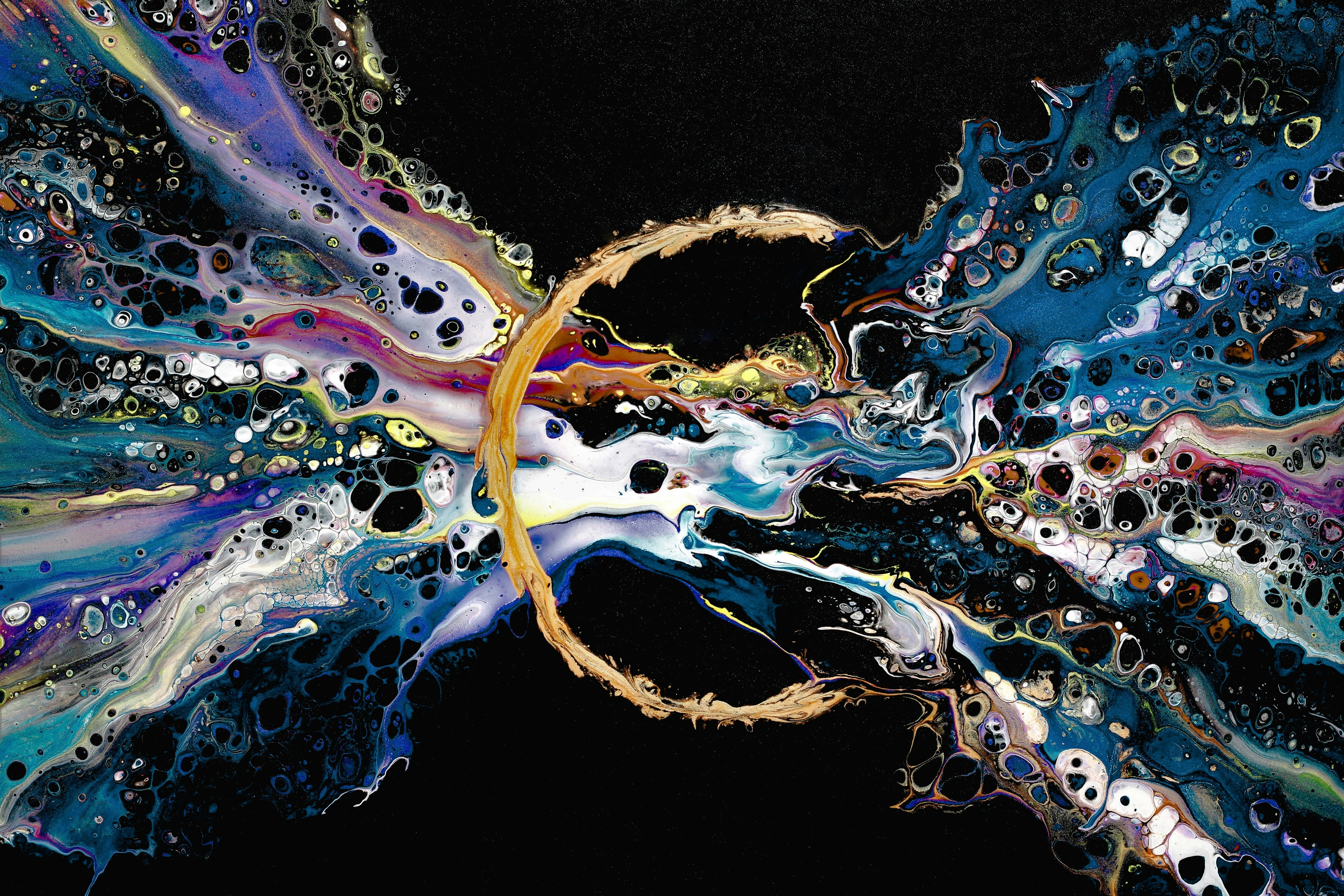 Abstract image in which flowing colours with bubbles flow through a golden ring against a black background