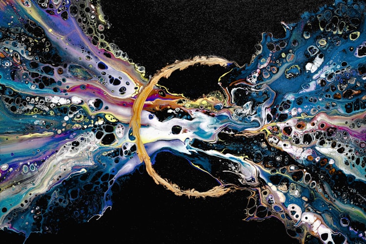 Abstract image in which flowing colours with bubbles flow through a golden ring against a black background
