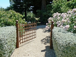 A completed fence and gate installation framing a neat garden path in a Melbourne home.