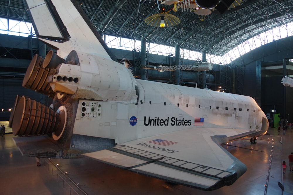 a large white airplane in a building