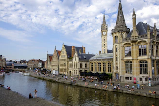 a clock tower next to a river