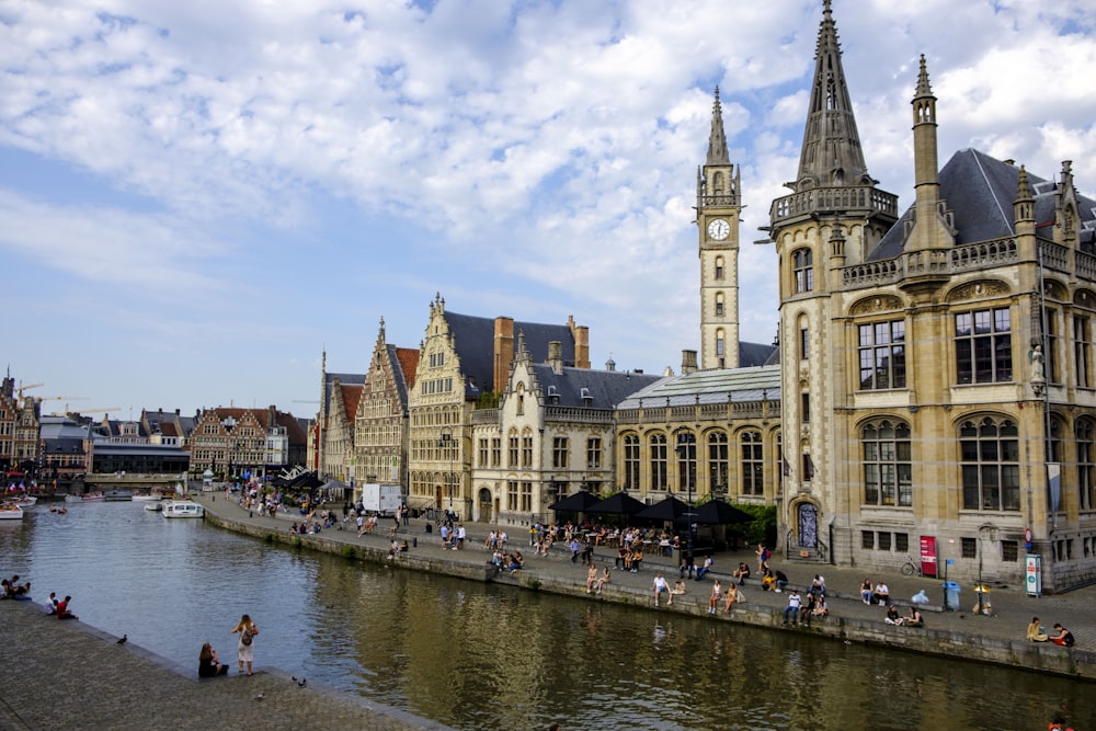 a clock tower next to a river