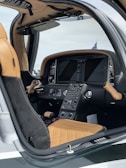 A close-up of gold-accented controls inside a high-end private jet cockpit.