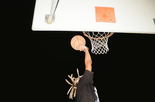 A Vancouver Bears player making a slam dunk with the crowd cheering in the background.