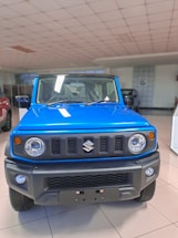 A friendly customer service representative assisting a user with vehicle inquiries.