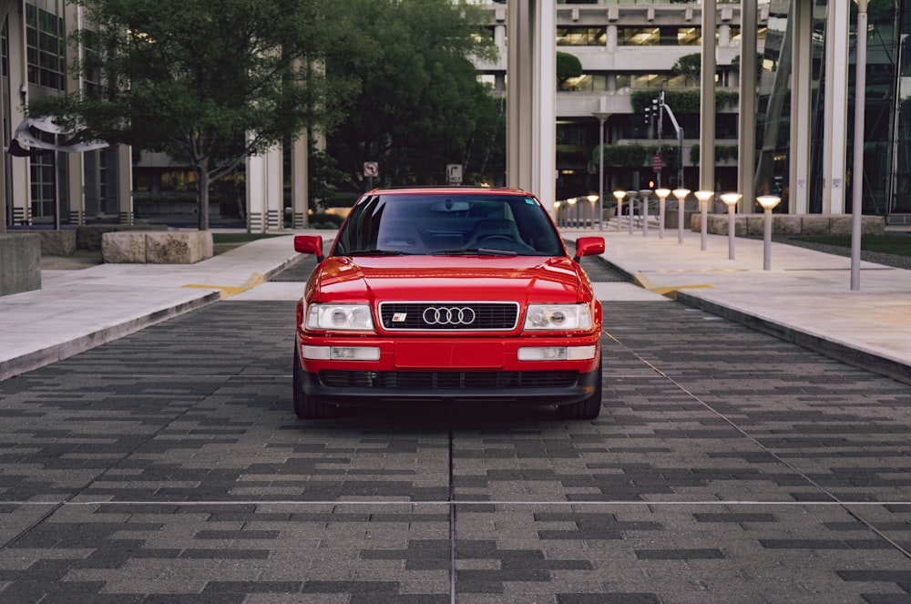 a red car parked on a brick road