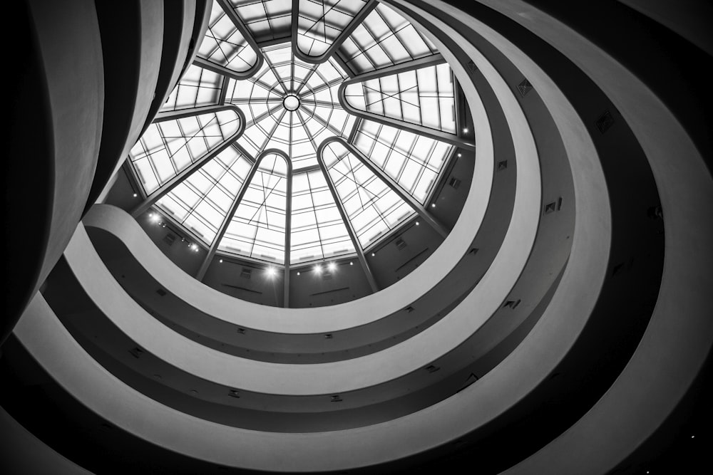 a spiral staircase with a spiral staircase with Solomon R. Guggenheim Museum in the background