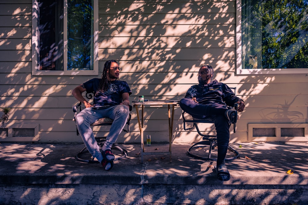 two men sitting on a bench