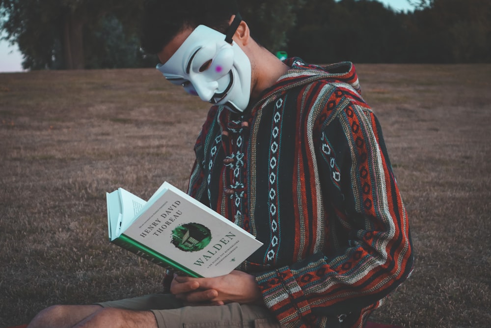 a person wearing a mask and holding a card