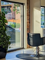 Bright, modern salon suite with large windows and stylish decor.