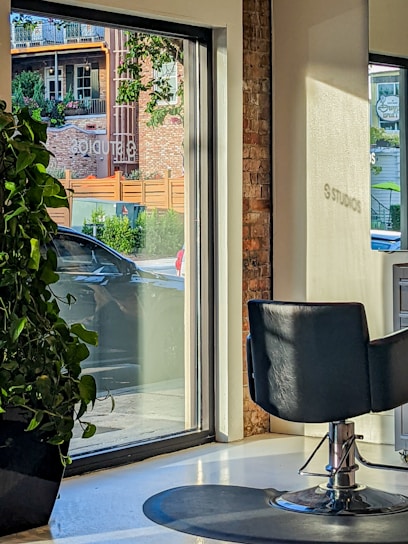 Cozy and elegant French hair salon interior with natural light and plants.