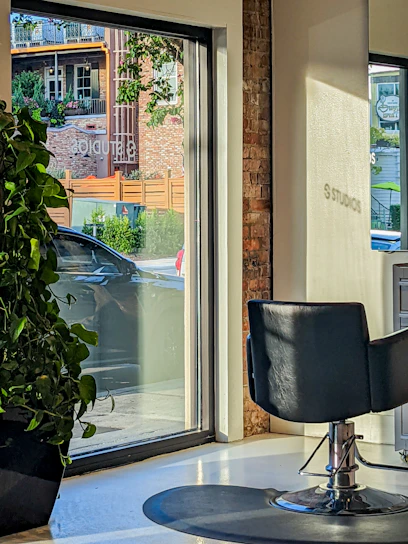 Bright, modern beauty salon interior with stylish furniture and large windows allowing natural light