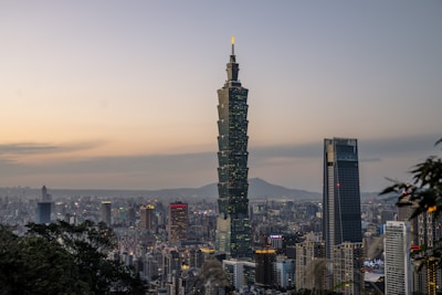 A panoramic view of Topaz Capital Ltd.'s headquarters with a city skyline backdrop at dusk.