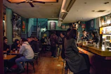 Bistro bar area with patrons enjoying cocktails and small plates near the bar.