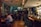 A cozy pub interior with patrons enjoying drinks and laughter.