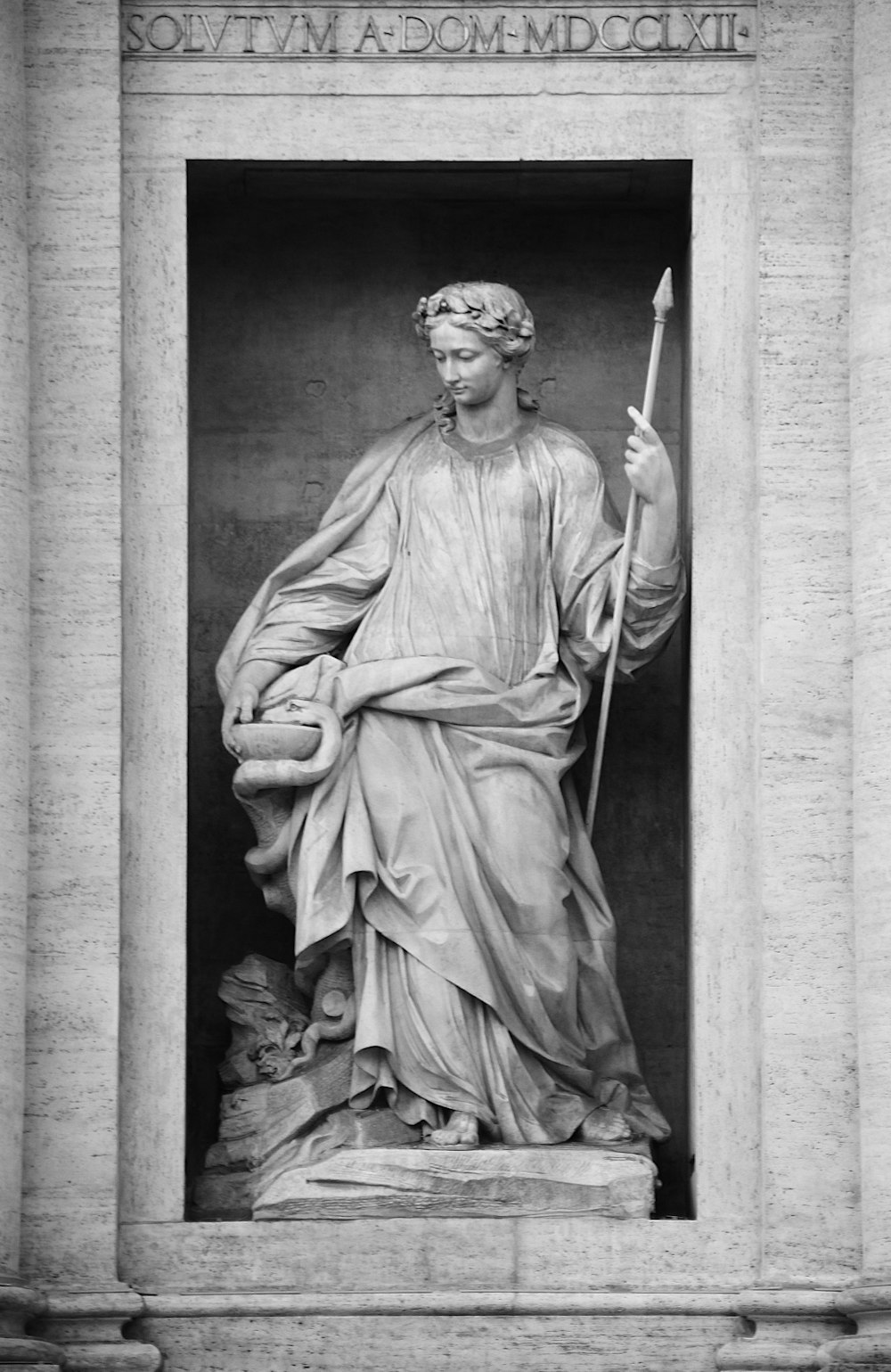 a statue of a man holding a staff