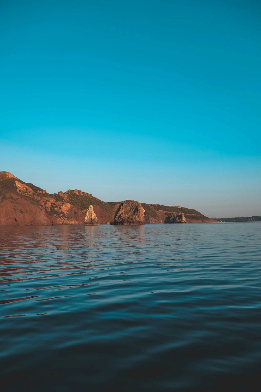 a body of water with mountains in the background