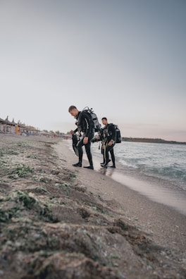 Group of scuba students preparing their gear on a sunny beach in Quintana Roo.