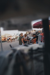 A friendly meeting in a sunny Sebring park where jewelry is being appraised.