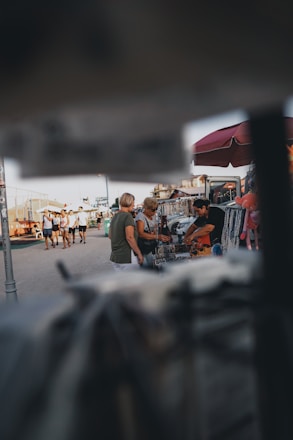 A friendly meeting in a sunny Sebring park where jewelry is being appraised.