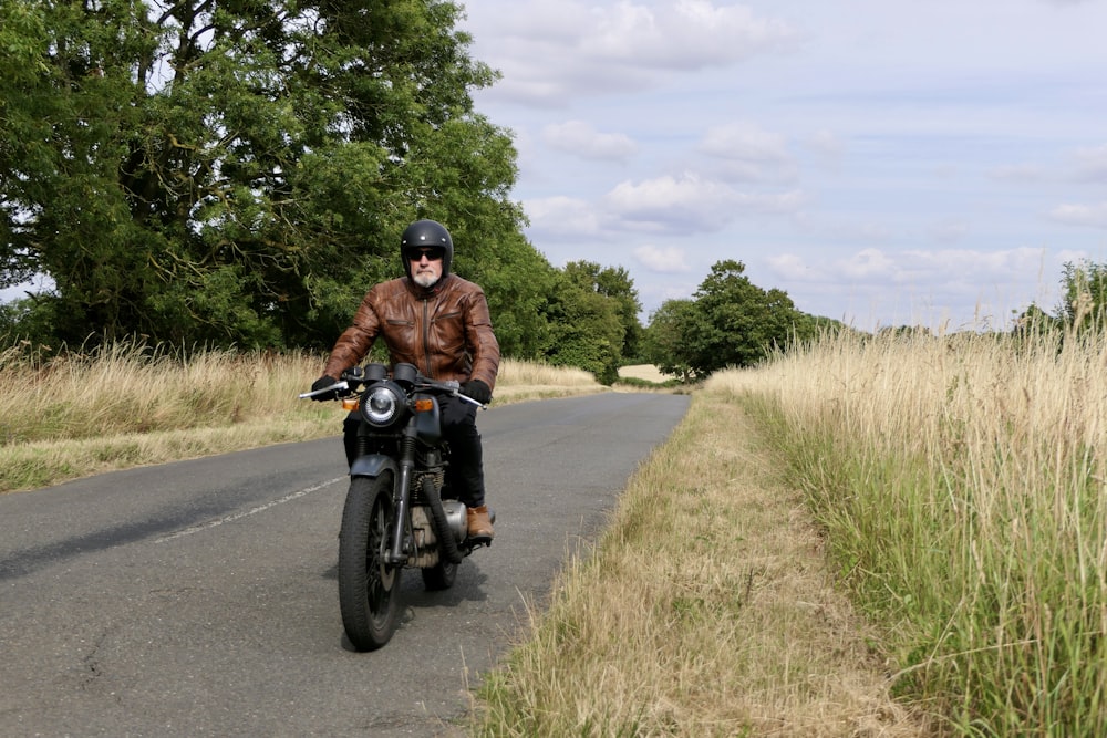 a man riding a motorcycle on a road