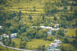 Scenic landscape featuring lush greenery and traditional houses.