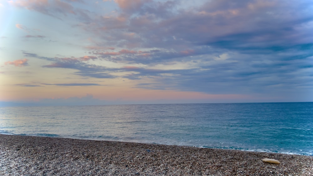 a beach with a body of water in the background