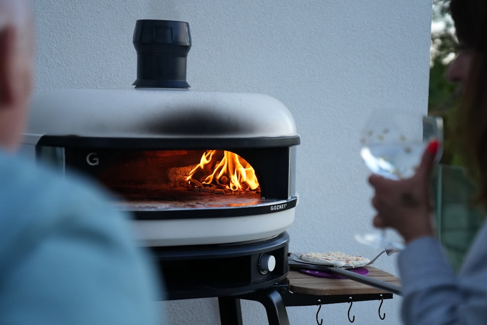 a person cooking food on a grill