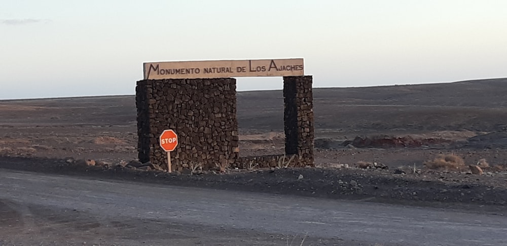 a sign on a rocky beach