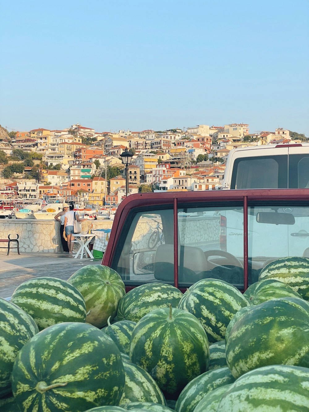 a van parked on a street with watermelons on the side