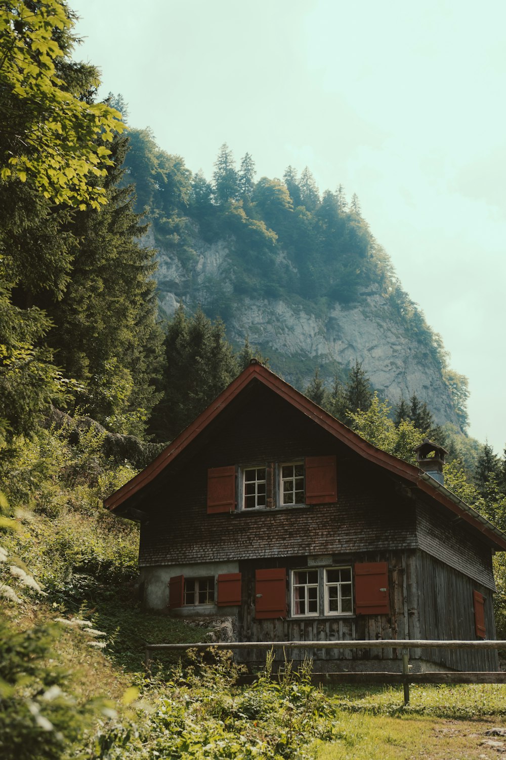 a wooden house in front of a mountain