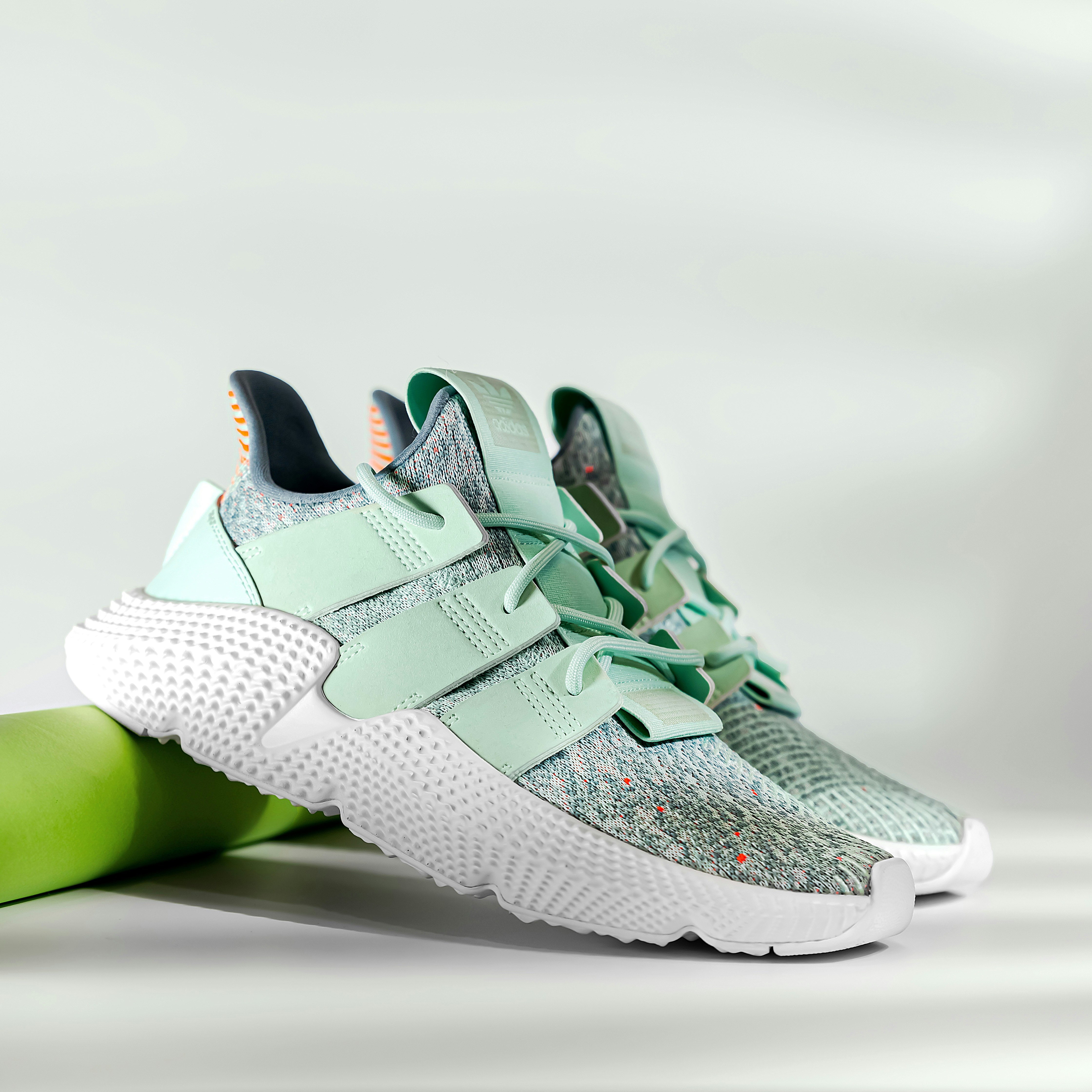 a pair of white and green sneakers