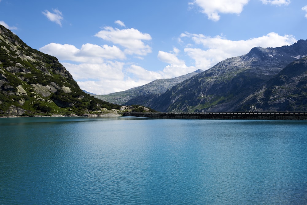 a body of water with mountains in the background