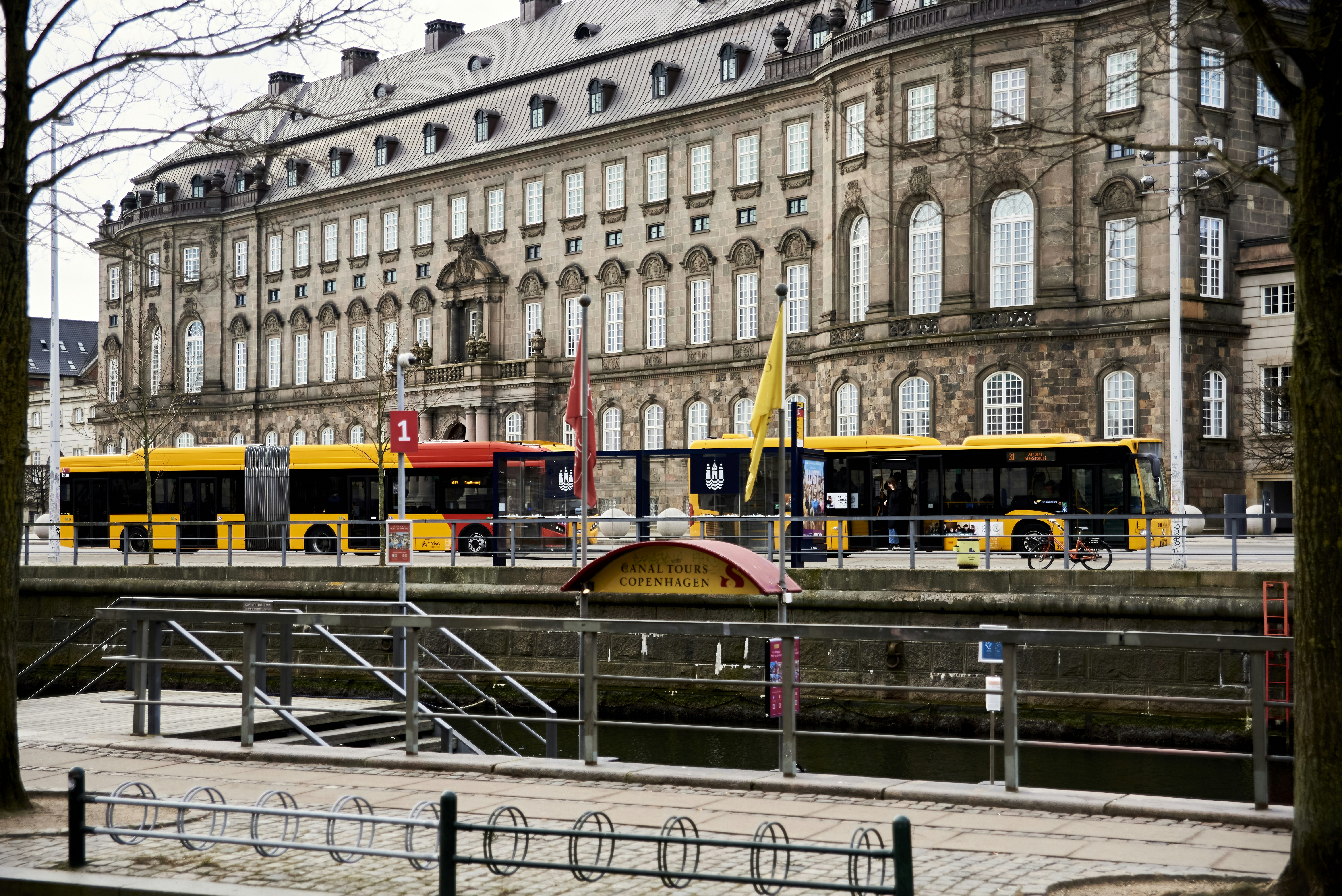 a couple of buses parked in front of a building