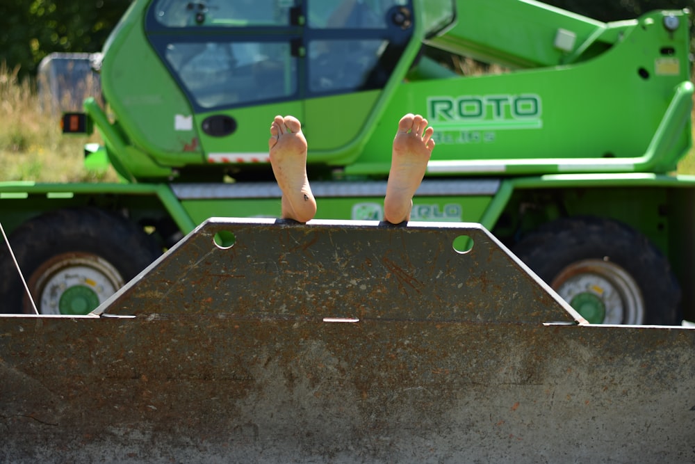 a person's foot on a car