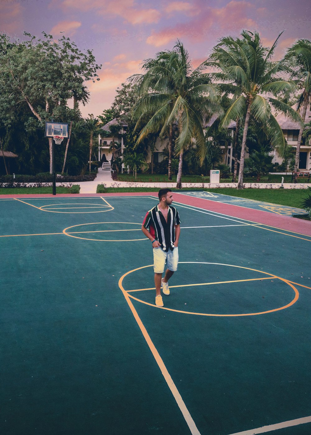 a young boy standing on a basketball court