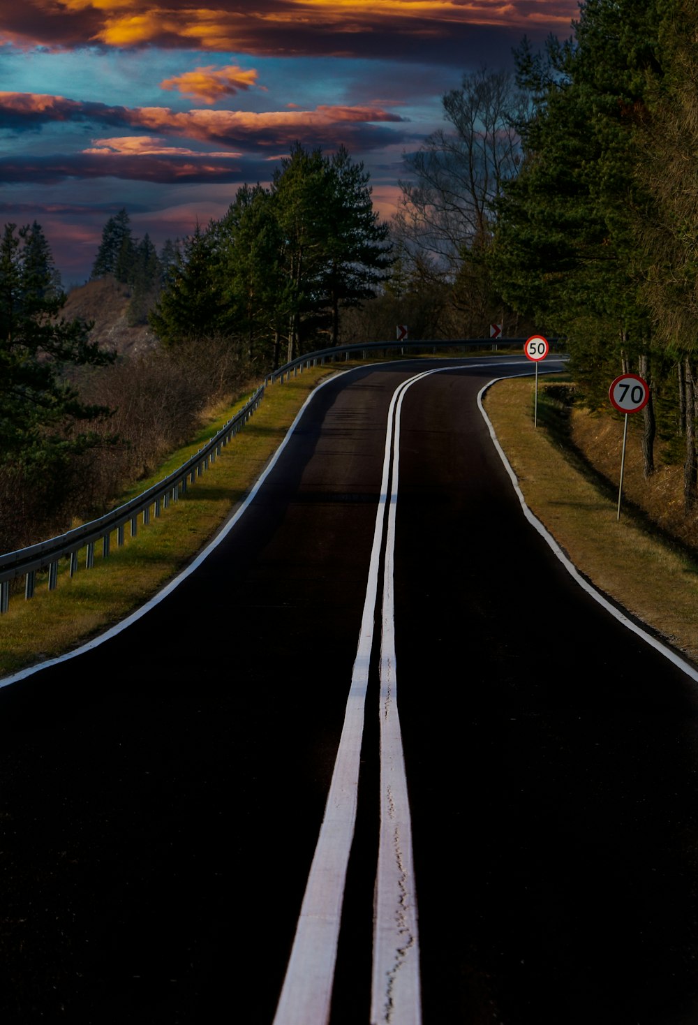 a train track with trees on the side